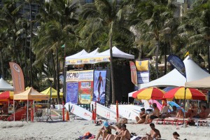 Link to image: http://i.imgur.com/SH4Uqrj.jpg  Caption: Most competitions will take place near Queen’s Surf in Waikiki, with the surf stand and exhibit booths fronting the majestic statue of Kahanamoku.  Caption: Most competitions will take place near Queen’s Surf in Waikiki, with the surf stand and exhibit booths fronting the majestic statue of Kahanamoku. 