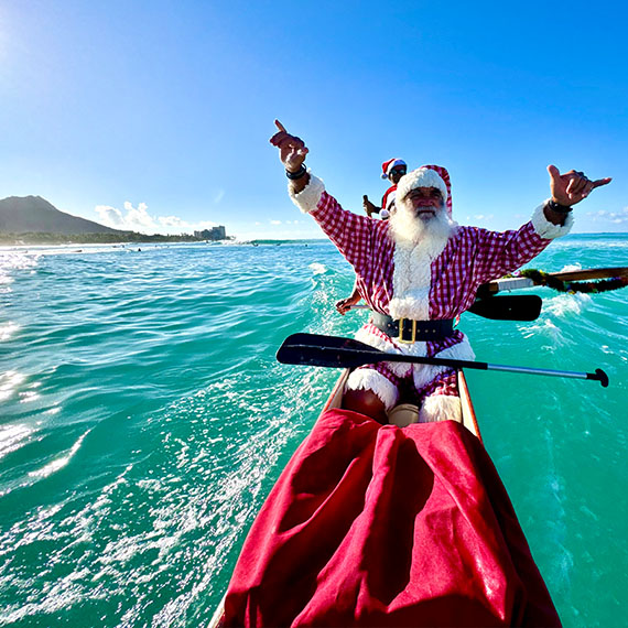 Santa Swaps His Sleigh for a Canoe at OUTRIGGER Waikīkī Beach Resort